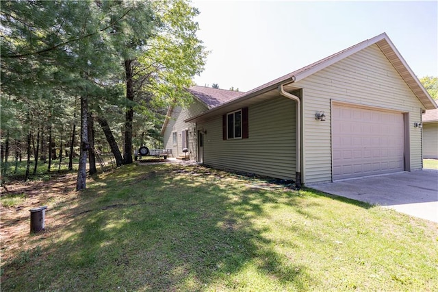 view of side of property with a lawn and a garage