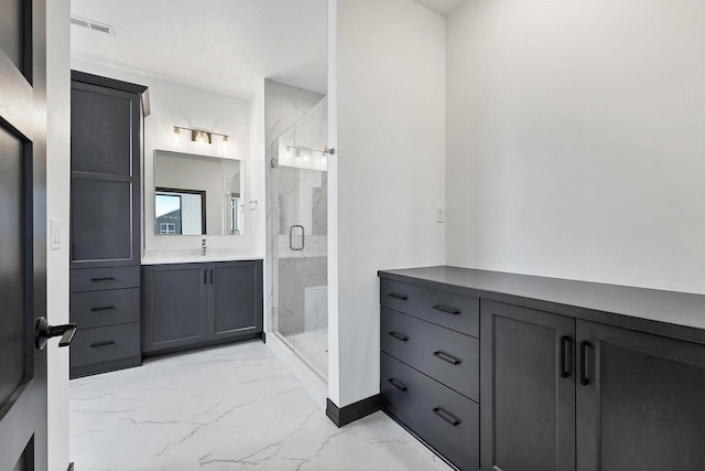 bathroom featuring marble finish floor, a marble finish shower, and vanity