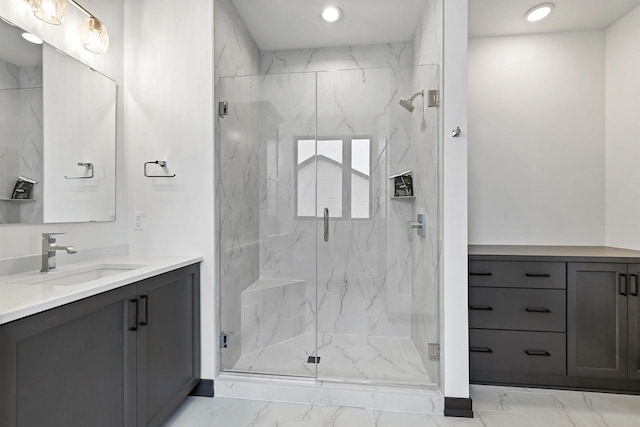 bathroom featuring marble finish floor, a marble finish shower, vanity, and recessed lighting