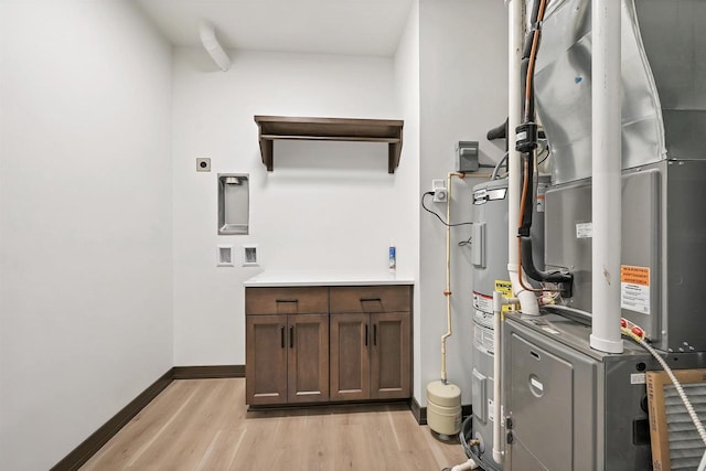 utility room with electric water heater and heating unit