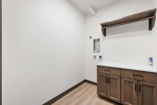 laundry room with cabinet space, baseboards, hookup for a washing machine, light wood-style floors, and electric dryer hookup