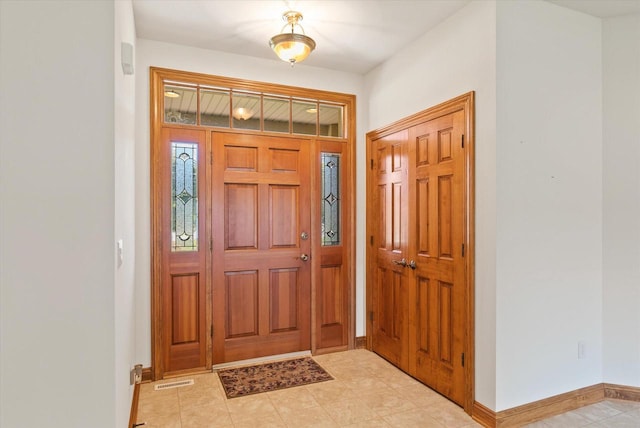 foyer entrance with light tile patterned floors