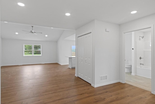 interior space with lofted ceiling, hardwood / wood-style flooring, and ceiling fan