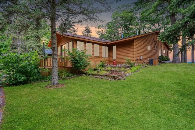 6874N Victory Heights Cir, Stone Lake, WI 54876 - view of side of property with a yard, central air condition unit, and a deck