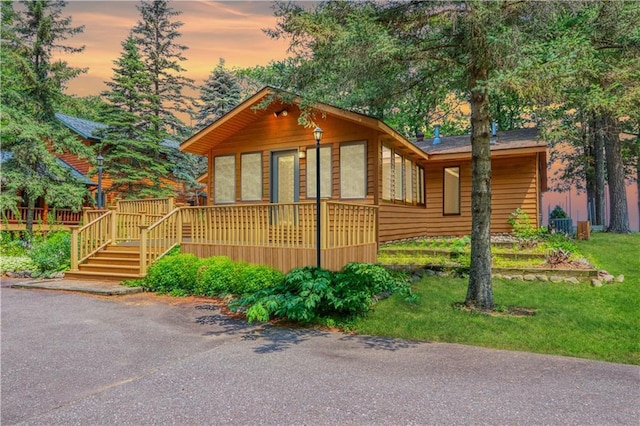 6874N Victory Heights Cir, Stone Lake, WI 54876 - view of front of home with a deck and a lawn