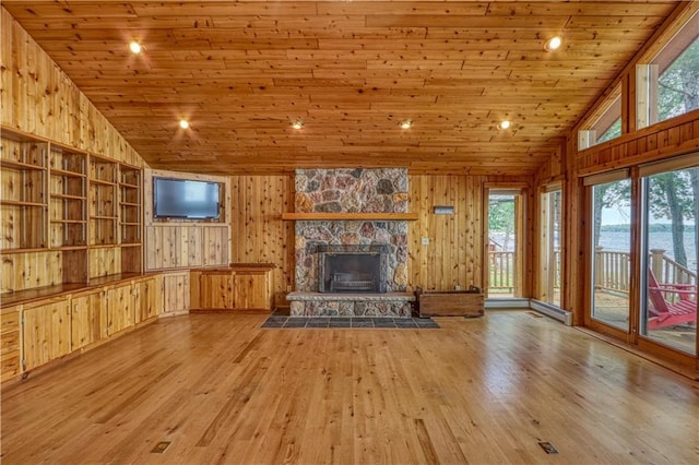 6874N Victory Heights Cir, Stone Lake, WI 54876 - unfurnished living room featuring vaulted ceiling, wood ceiling, wood walls, wood finished floors, and a fireplace