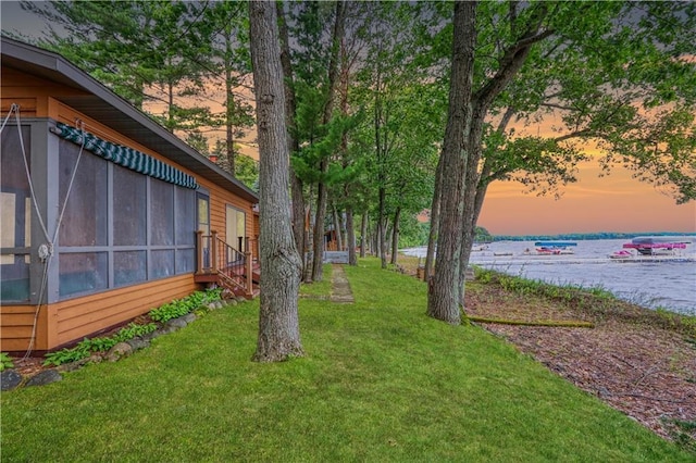 6874N Victory Heights Cir, Stone Lake, WI 54876 - yard at dusk featuring a water view, a sunroom, and a yard