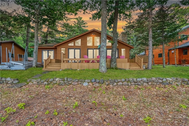 6874N Victory Heights Cir, Stone Lake, WI 54876 - rear view of house featuring a wooden deck and a yard