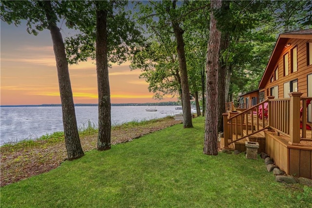 6874N Victory Heights Cir, Stone Lake, WI 54876 - yard at dusk with a water view and a lawn