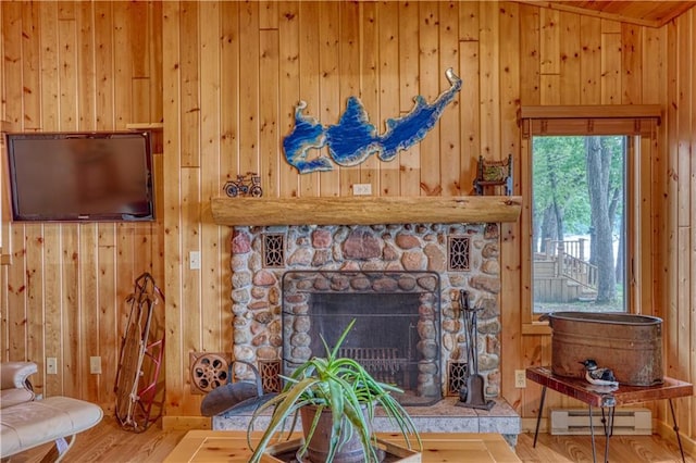 6874N Victory Heights Cir, Stone Lake, WI 54876 - living room with baseboard heating, wooden walls, wood finished floors, and a fireplace