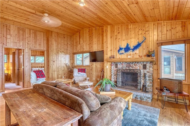 6874N Victory Heights Cir, Stone Lake, WI 54876 - living room with wooden ceiling, a fireplace, wooden walls, a baseboard radiator, and vaulted ceiling