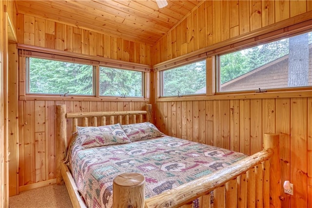 6874N Victory Heights Cir, Stone Lake, WI 54876 - bedroom with multiple windows, lofted ceiling, wood walls, and carpet
