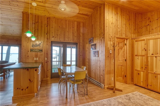 6874N Victory Heights Cir, Stone Lake, WI 54876 - dining space featuring wooden ceiling, a baseboard heating unit, wooden walls, light wood-style flooring, and high vaulted ceiling