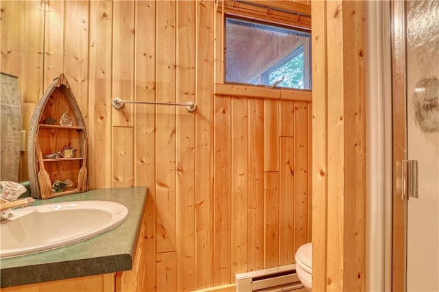 6874N Victory Heights Cir, Stone Lake, WI 54876 - bathroom with wooden walls, vanity, a baseboard heating unit, and toilet