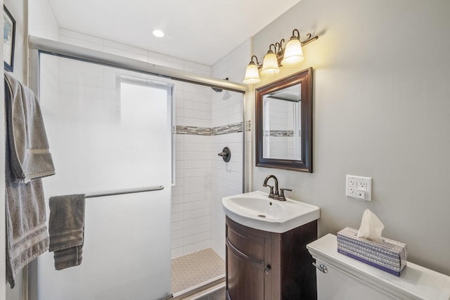 bathroom featuring vanity, walk in shower, and toilet