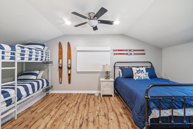 bedroom with ceiling fan, lofted ceiling, and light hardwood / wood-style floors