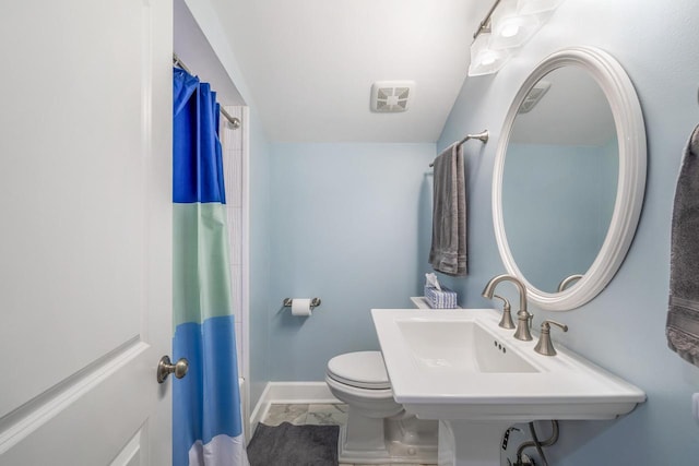 bathroom featuring walk in shower and toilet