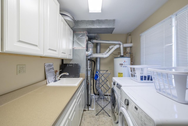 washroom featuring cabinets, sink, gas water heater, and independent washer and dryer