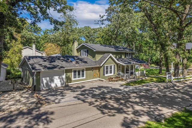 view of front of property with covered porch and a garage