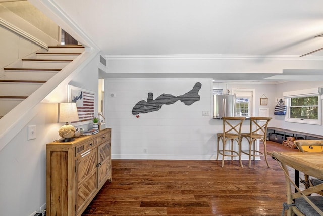 interior space with crown molding and dark wood-type flooring