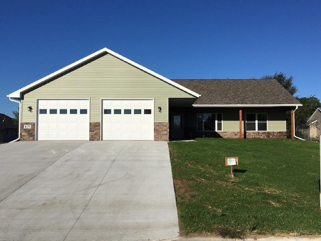 single story home featuring a garage and a front lawn