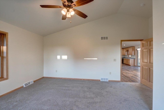 425 Mourning Dove Ct, Arena, WI 53503 - spare room featuring light carpet, a ceiling fan, baseboards, and high vaulted ceiling