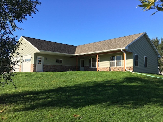 single story home featuring a garage and a front lawn