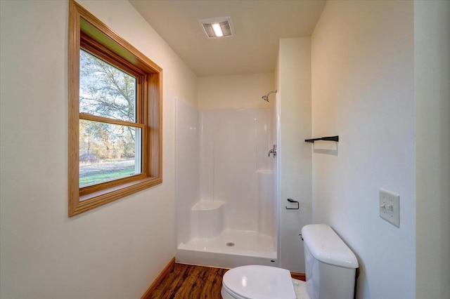 425 Mourning Dove Ct, Arena, WI 53503 - full bathroom featuring toilet, a shower, wood finished floors, and baseboards