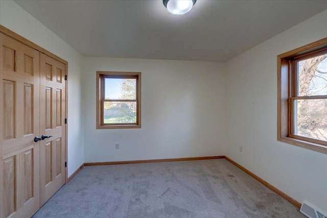 425 Mourning Dove Ct, Arena, WI 53503 - unfurnished bedroom featuring light colored carpet, baseboards, and a closet