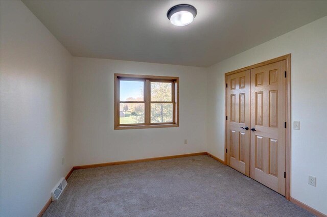 425 Mourning Dove Ct, Arena, WI 53503 - unfurnished bedroom with carpet, baseboards, and a closet