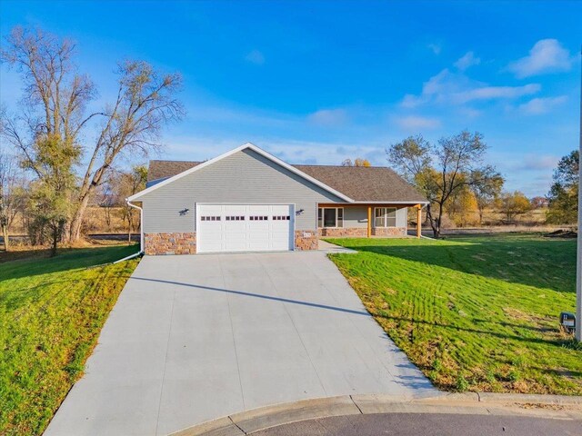 425 Mourning Dove Ct, Arena, WI 53503 - ranch-style house featuring stone siding, a front lawn, a garage, and concrete driveway