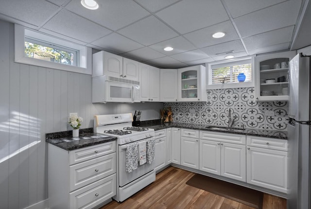 N1814 Highland Rd, Lake Geneva, WI 53147 - kitchen featuring white appliances, a sink, glass insert cabinets, dark wood-style flooring, and healthy amount of natural light