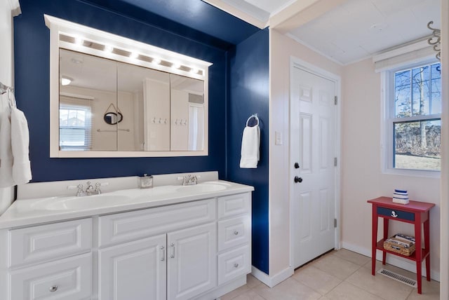 N1814 Highland Rd, Lake Geneva, WI 53147 - bathroom featuring double vanity, healthy amount of natural light, tile patterned flooring, baseboards, and crown molding