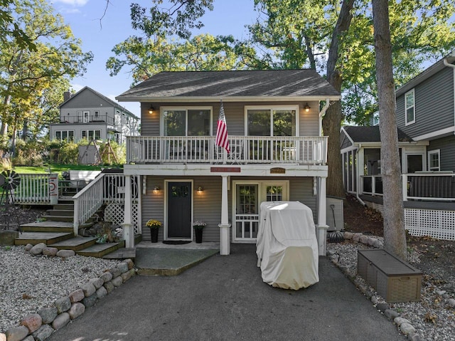 N1814 Highland Rd, Lake Geneva, WI 53147 - view of front of home with stairway, a patio area, and a wooden deck