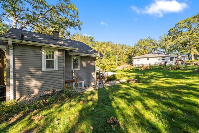 N1814 Highland Rd, Lake Geneva, WI 53147 - back of property with a chimney, a lawn, and a shingled roof