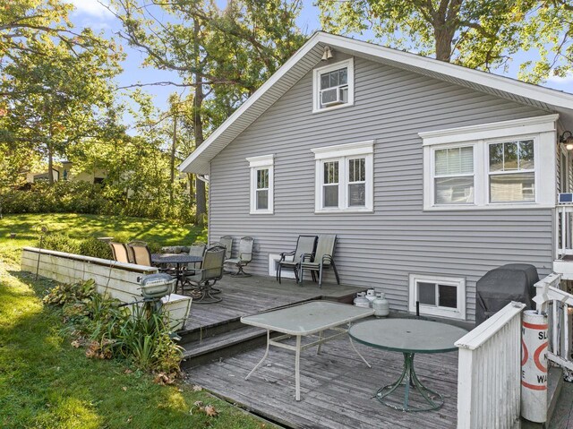 N1814 Highland Rd, Lake Geneva, WI 53147 - back of property with a wooden deck, a lawn, and outdoor dining space