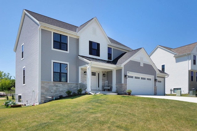 view of front facade with a front yard, a garage, and covered porch