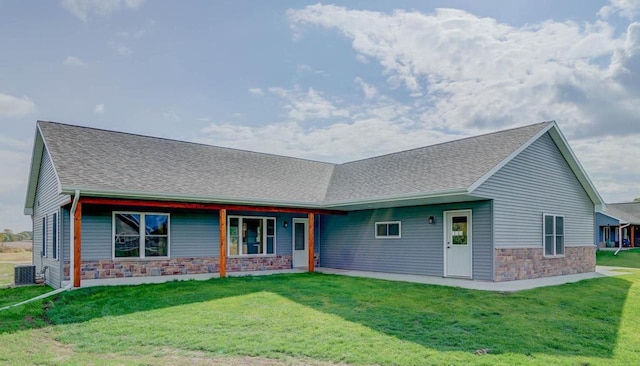 view of front of house with cooling unit and a front yard