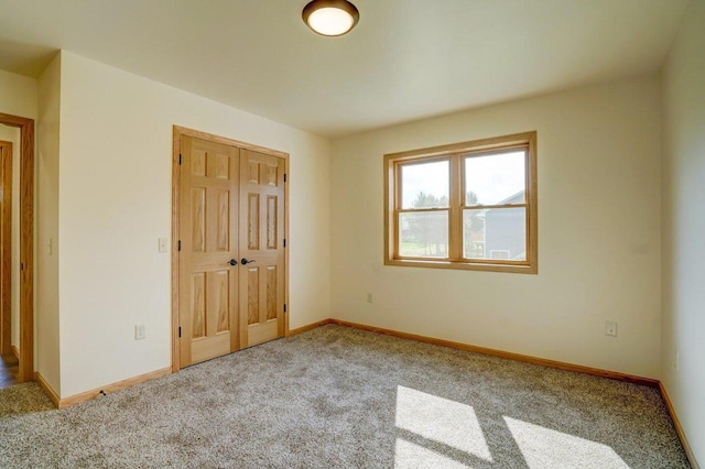 unfurnished bedroom featuring a closet and light colored carpet