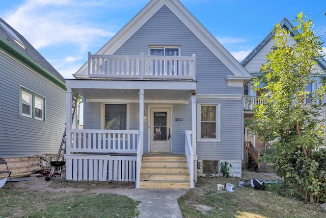 view of front of property with a porch and a balcony