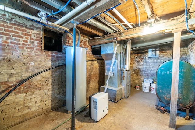 basement with heating unit, brick wall, and water heater