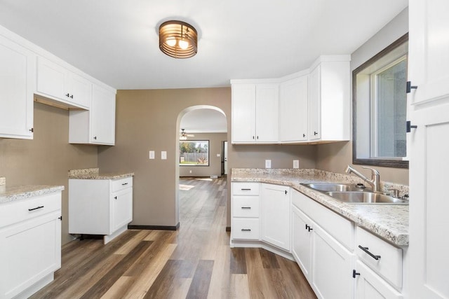 kitchen featuring ceiling fan, white cabinetry, sink, and dark hardwood / wood-style flooring