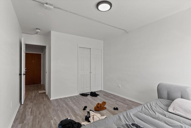 bedroom featuring light hardwood / wood-style flooring and a closet