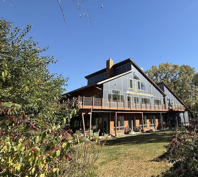 rear view of house featuring a lawn