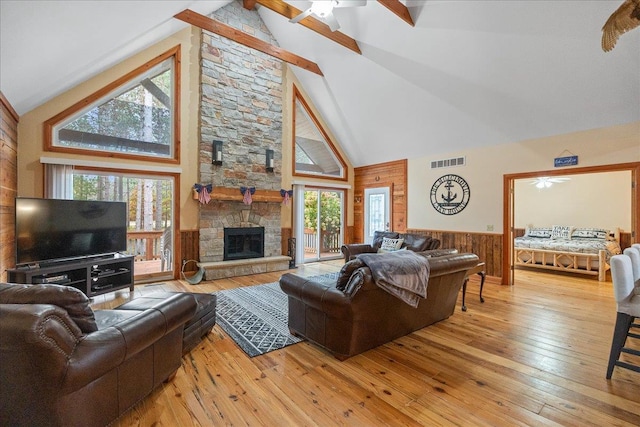 living room featuring hardwood / wood-style flooring, a healthy amount of sunlight, and high vaulted ceiling