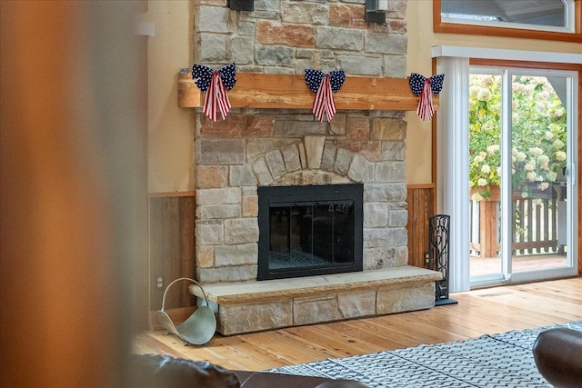 details featuring hardwood / wood-style flooring and a stone fireplace