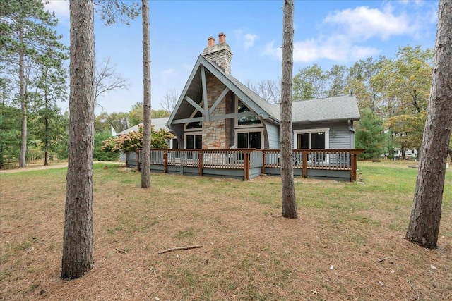 back of property featuring a yard and a wooden deck