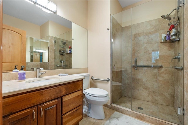 bathroom featuring vanity, toilet, an enclosed shower, and tile patterned floors