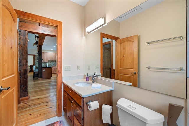 bathroom featuring hardwood / wood-style flooring, vanity, and toilet