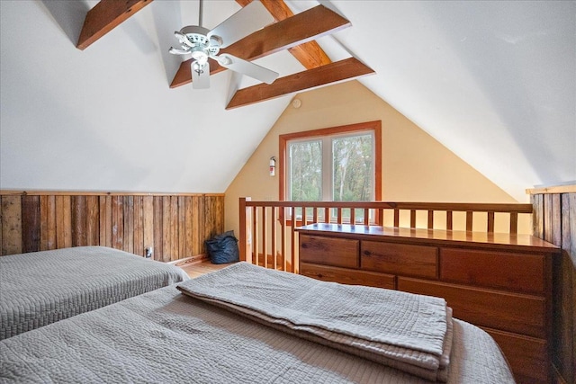 bedroom featuring ceiling fan, vaulted ceiling with beams, and wood walls